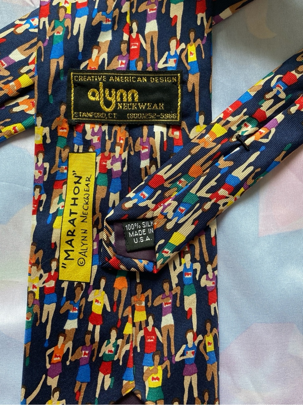 Alynn Neckwear 100% Silk Marathon Print Tie in Navy with Multicolor Figures - Picture 2 of 10